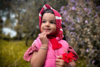 A Girl Wearing a Pink Baby Vest